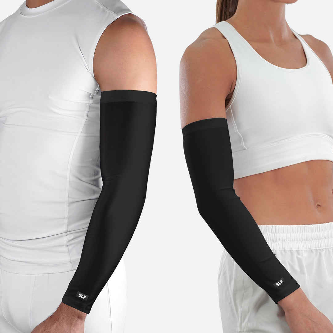 Black arm sleeves worn by a person on a white background