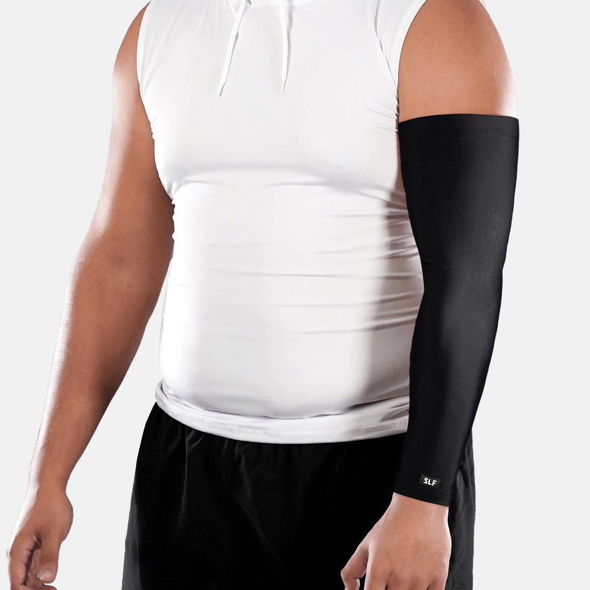 Person wearing a black arm sleeve on one arm against a white background