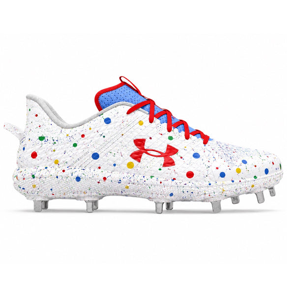 Under Armour Yard MT low-top baseball cleats in white with multicolor red, blue, yellow and green confetti dot splatter print, red Under Armour logo, red laces, blue collar, and metal spikes on white background by Stadium Custom Kicks.