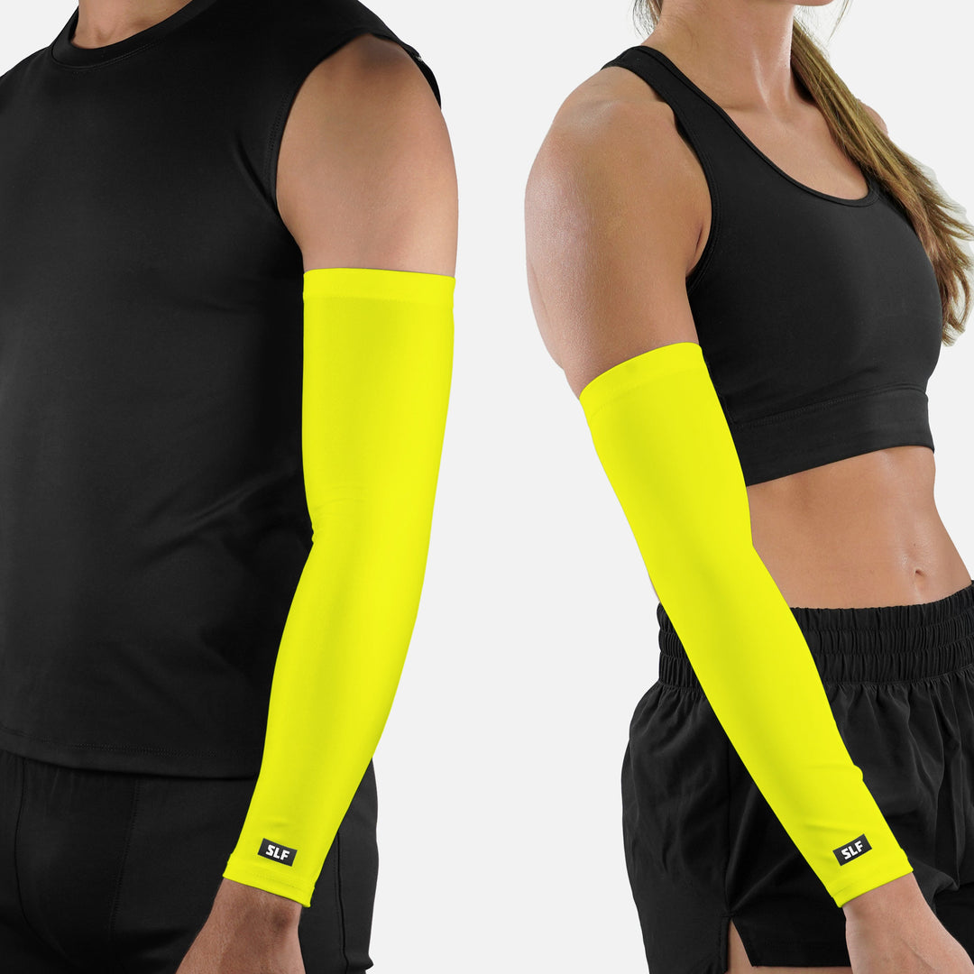 Two people wearing bright yellow arm sleeves on a white background