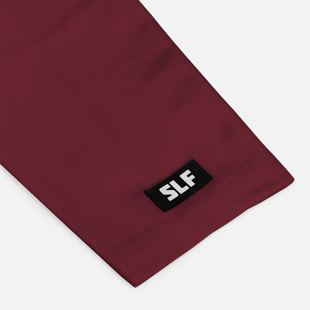 Maroon fabric with a black label featuring 'SLF' on a white background