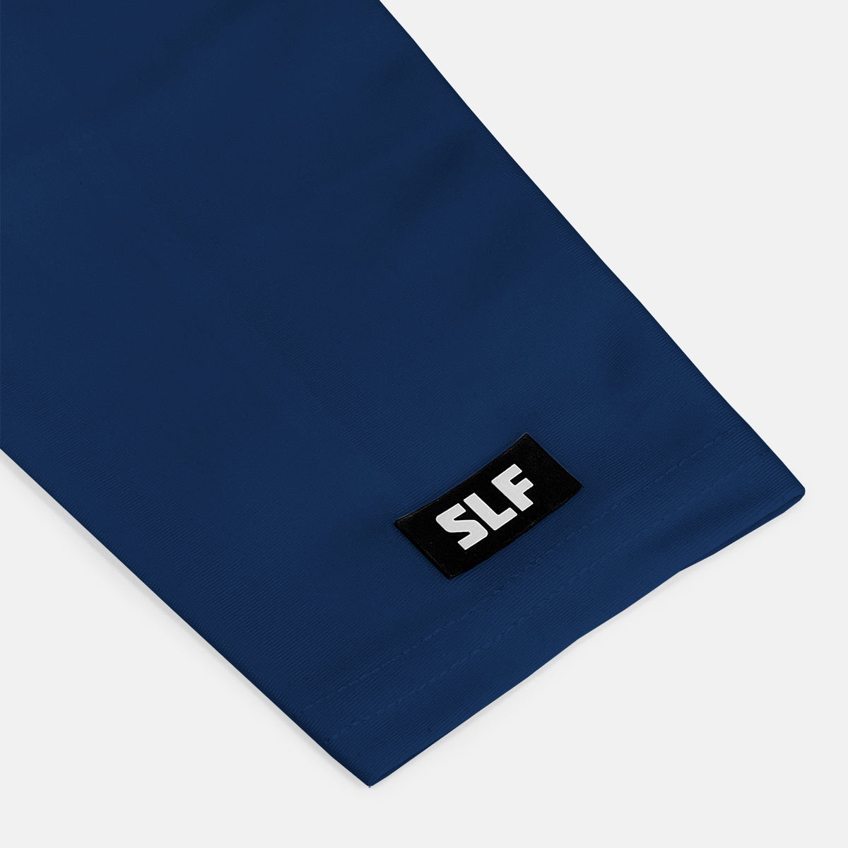 Navy blue fabric with a black label featuring 'SLF' on a white background