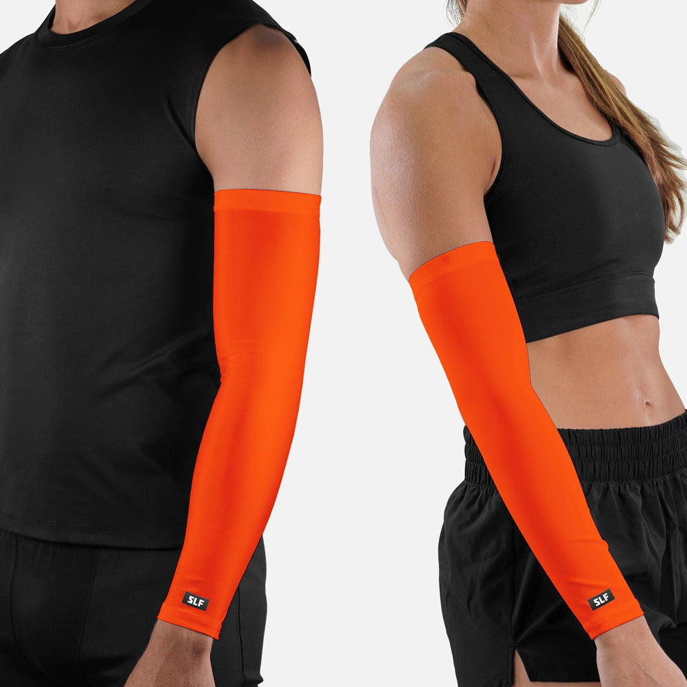 Two people wearing black athletic wear with bright orange arm sleeves on a white background.