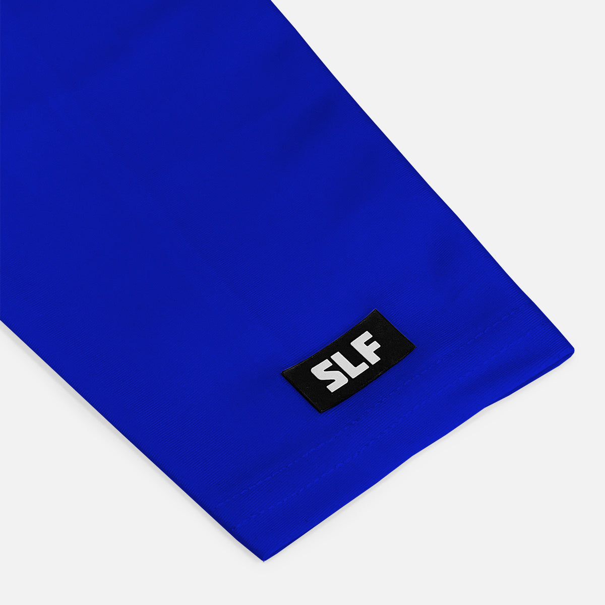 Blue fabric with a black label featuring 'SLF' on a white background