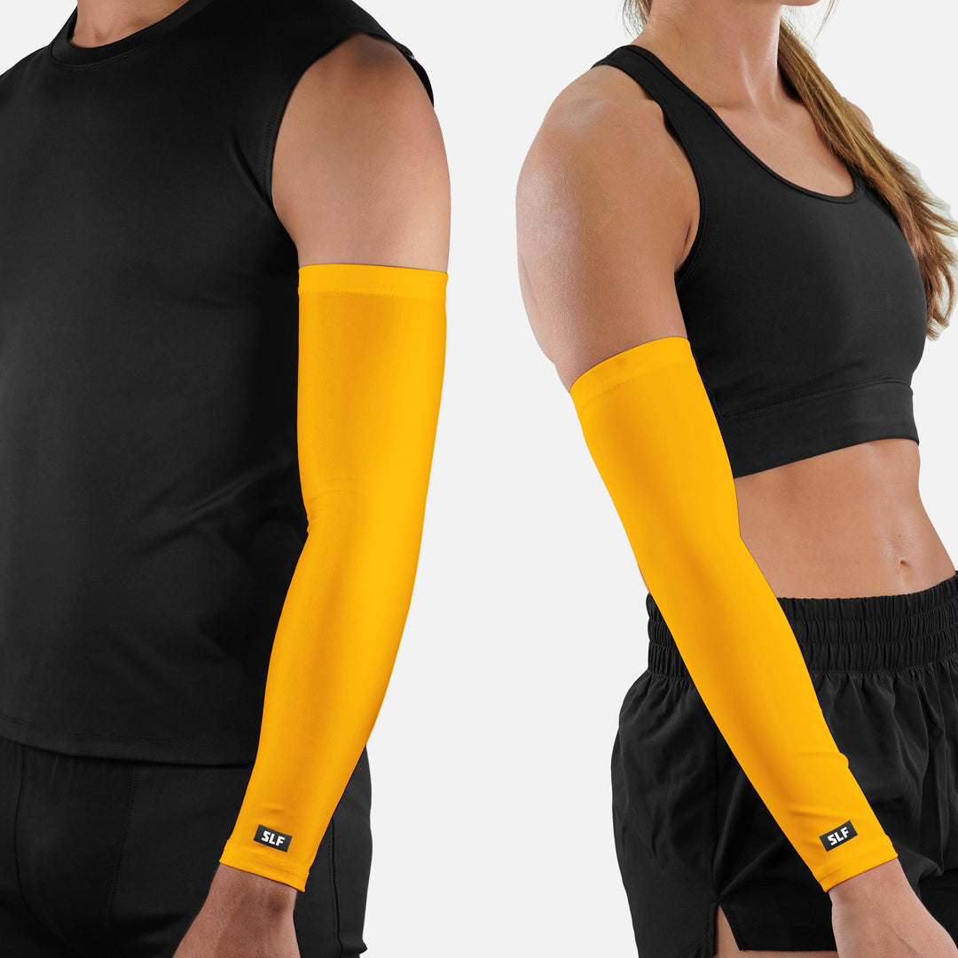 Two people wearing black athletic wear with yellow arm sleeves on a white background