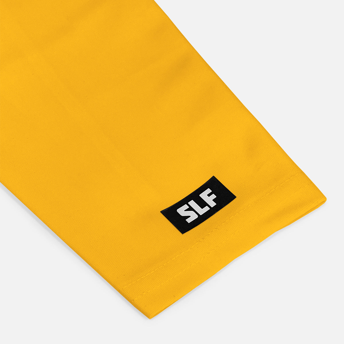 Yellow fabric with a black label featuring 'SLF' on a white background