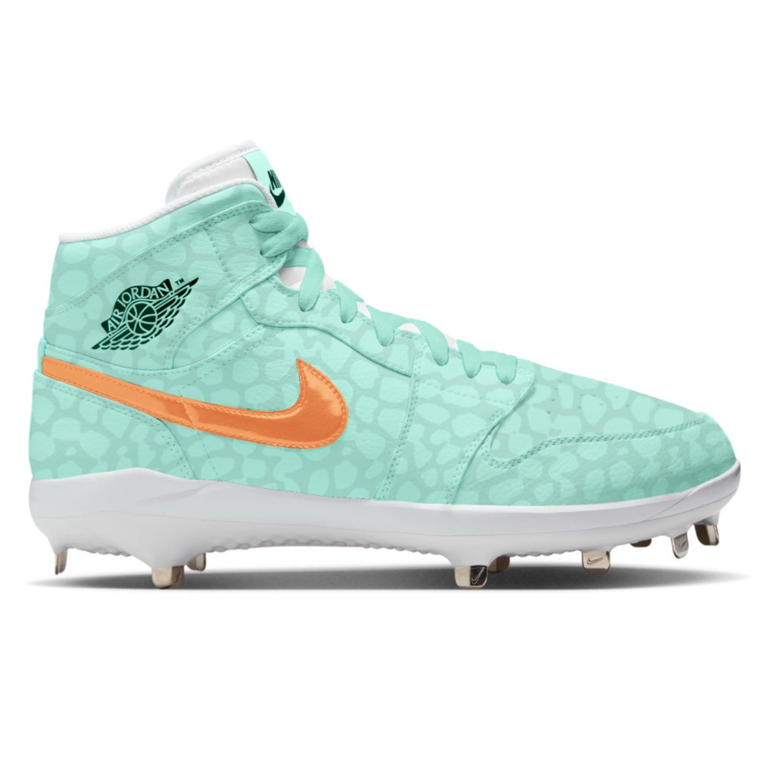 Custom mint green Jordan 1 Retro mid baseball cleats with orange Swoosh and tonal leopard print pattern by Stadium Custom Kicks
