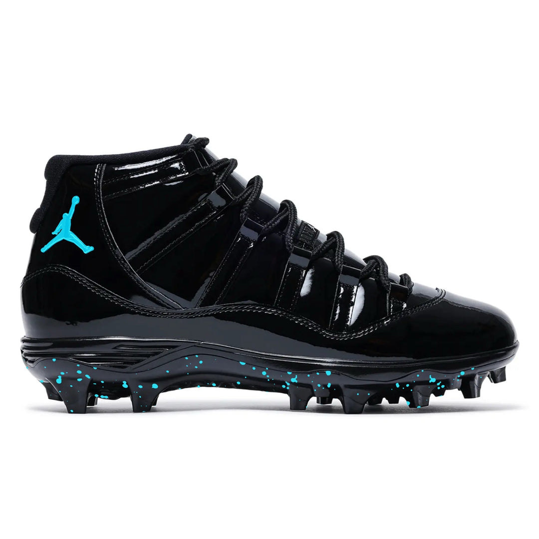 Plasma Blue Jordan 11 Retro TD football cleats in all black with turquoise Jumpman logo and turquoise paint splatter detailing on the outsole by stadium custom kicks.