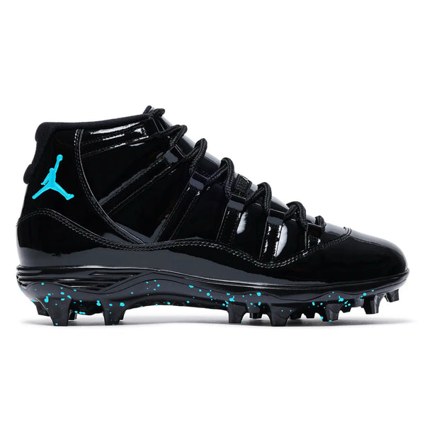 Plasma Blue Jordan 11 Retro TD football cleats in all black with turquoise Jumpman logo and turquoise paint splatter detailing on the outsole by stadium custom kicks.