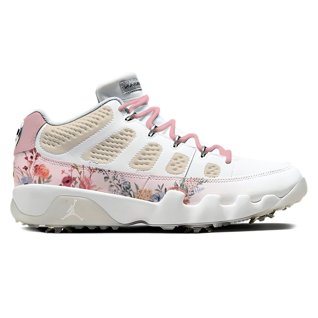 Air Jordan 9 Retro Low golf shoes in white and pink with floral botanical print along the midsole panel, pink laces, and metal golf spikes on white background by Stadium Custom Kicks