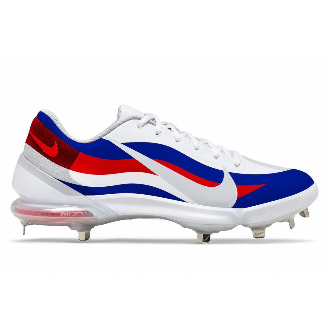 A Nike baseball cleat in white, blue, and red, featuring the Nike Swoosh and Air Zoom technology in the translucent sole, shown against a plain white background.