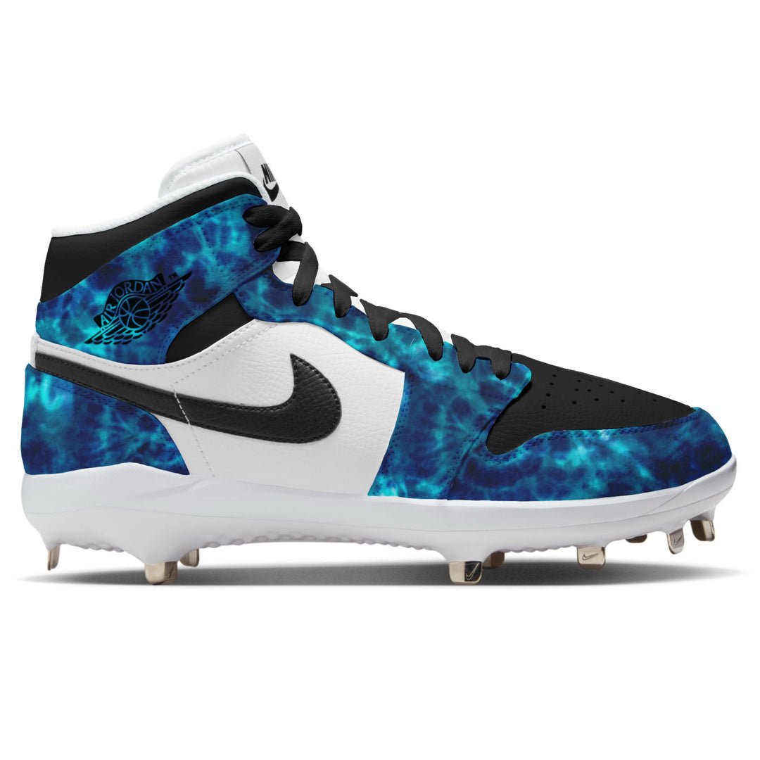 Aurora Tie Dye Jordan 1 Retro Baseball Cleats in white and black featuring a blue and teal tie dye pattern, Air Jordan Wings logo, black Nike Swoosh, and metal spike outsole by Stadium Custom Kicks