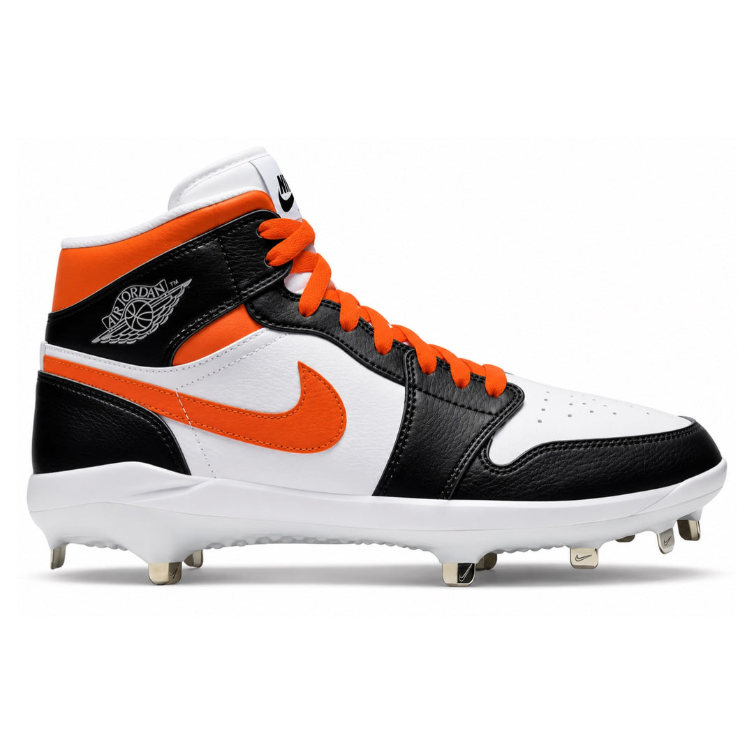 A Nike high-top baseball cleat in black, white, and orange, featuring a white leather toe box, black leather overlays, a white Nike Swoosh, and an orange Nike logo on the side. The shoe has orange laces, a white midsole, and metal cleats on a white background.