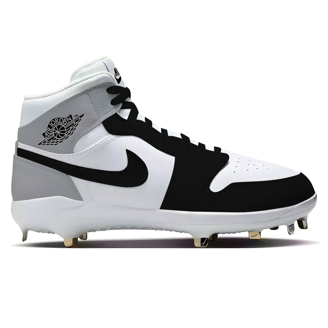 Black, white, and gray Jordan 1 Retro Barons baseball cleats on a white background