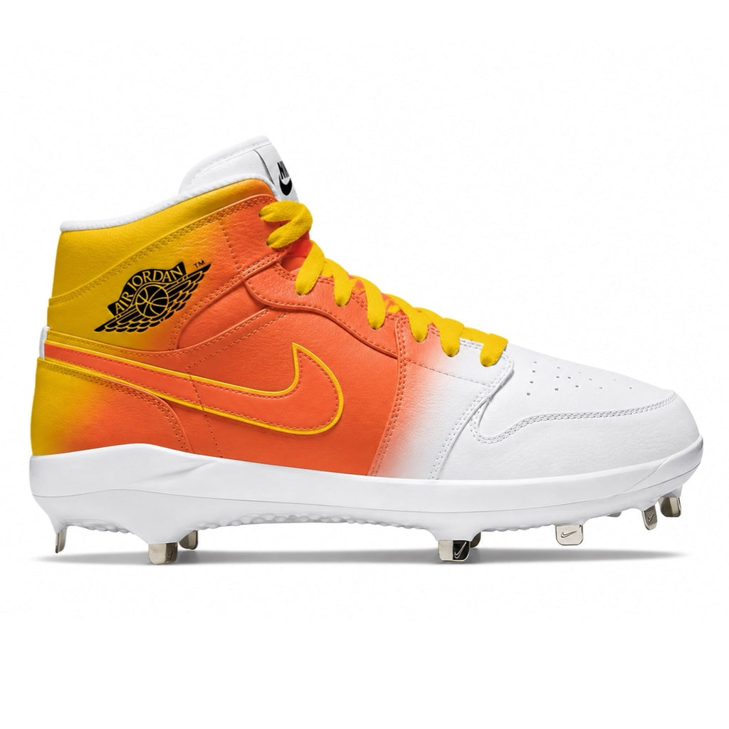 Orange, yellow, and white cleated shoe with Nike logo on a white background