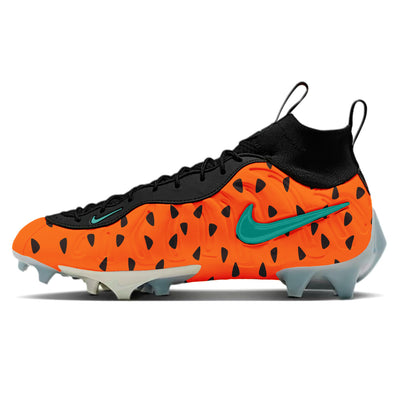 A pair of Nike Vaporposite Pro football cleats with a Flintstones theme, featuring a bright orange base with irregular black spots resembling Fred Flintstone’s iconic shirt pattern.