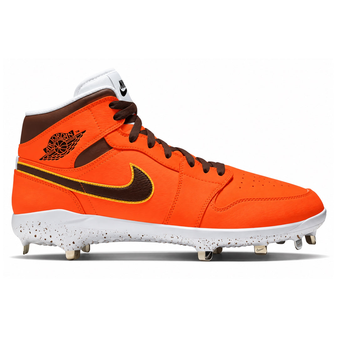 A Nike Air Jordan high-top baseball cleat in bright orange, brown, and white, featuring a brown suede side panel with a black Jumpman logo, a black swoosh outlined in yellow, and white studs on a white sole.
