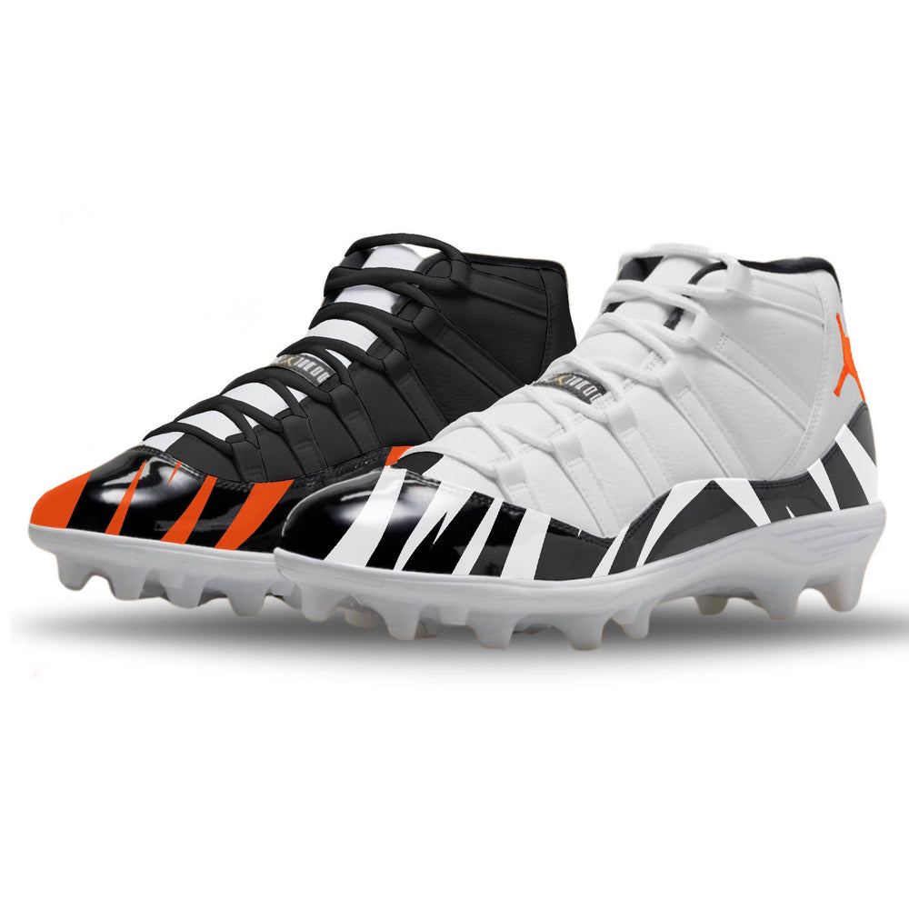 Pair of black, white, and orange cleats on a white background