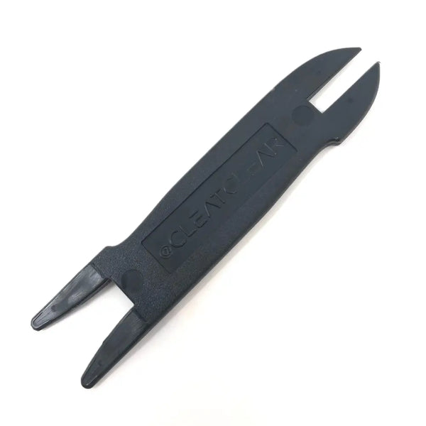 Black plastic slotted tool used for removing dirt and clean from cleated footwear