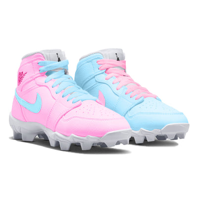light blue and pink mismatched mid top youth cleats in a side view.