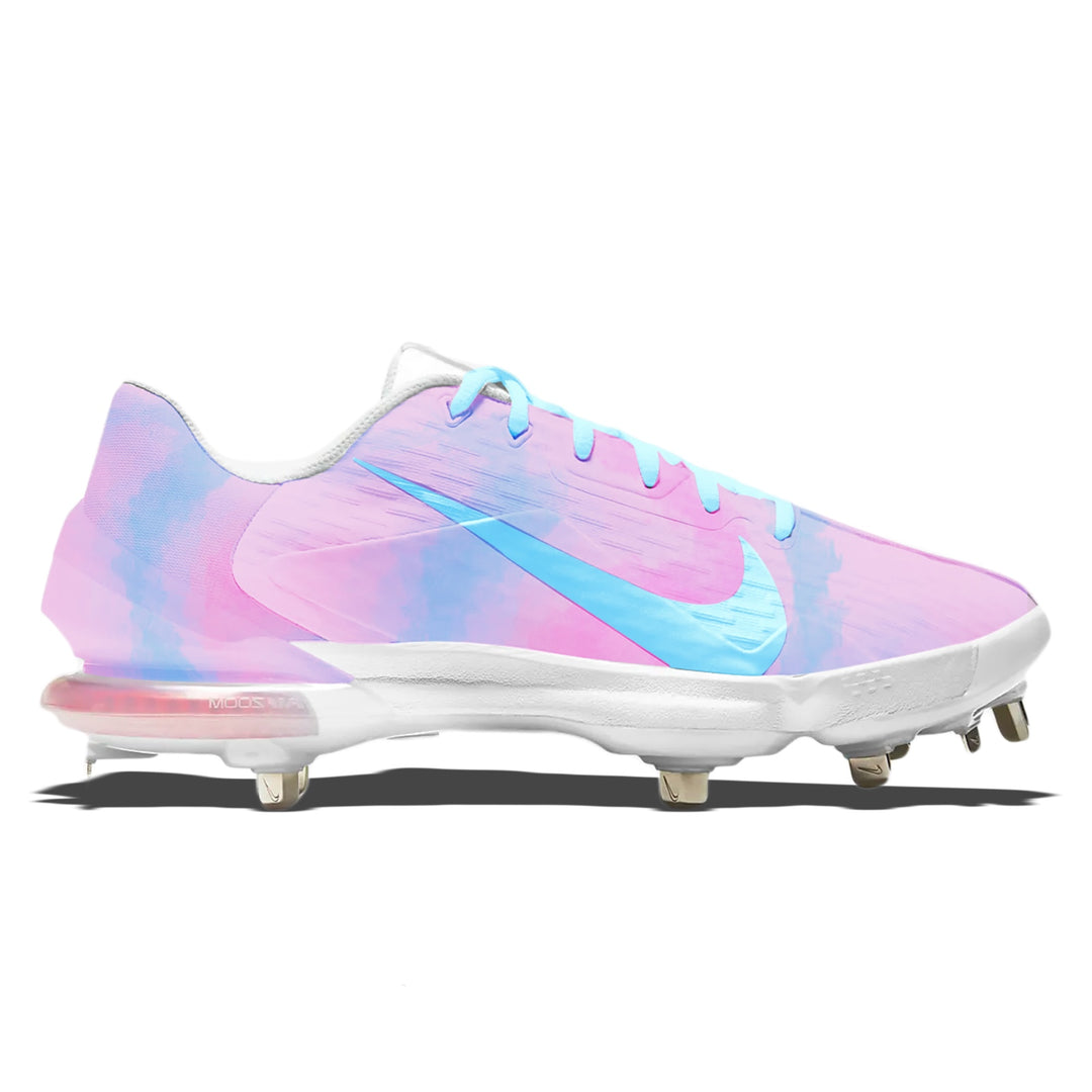 A Nike baseball cleat featuring a pastel pink and blue watercolor gradient design, with a light blue Nike Swoosh and matching laces, shown from a side profile on a white background.