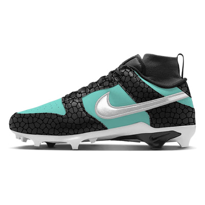 Custom emerald Nike Alpha Menace Dunk football cleats featuring teal panels, a black cracked-stone textured overlay, and a metallic silver Nike swoosh.