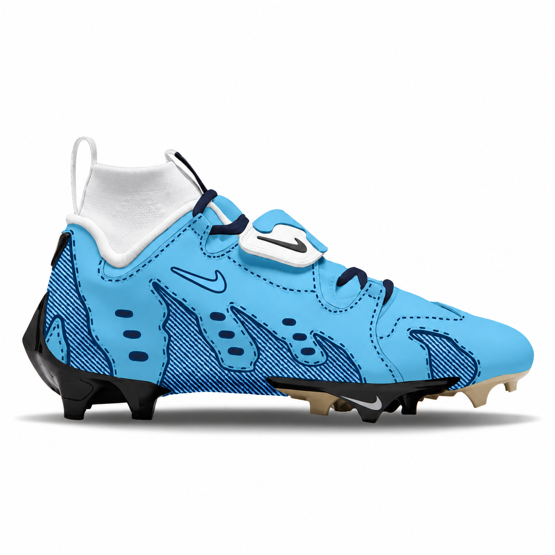 A Nike football cleat in light blue with dark blue flame-like patterns, a white hook-and-loop strap closure, and black studs, shown from the side on a white background.