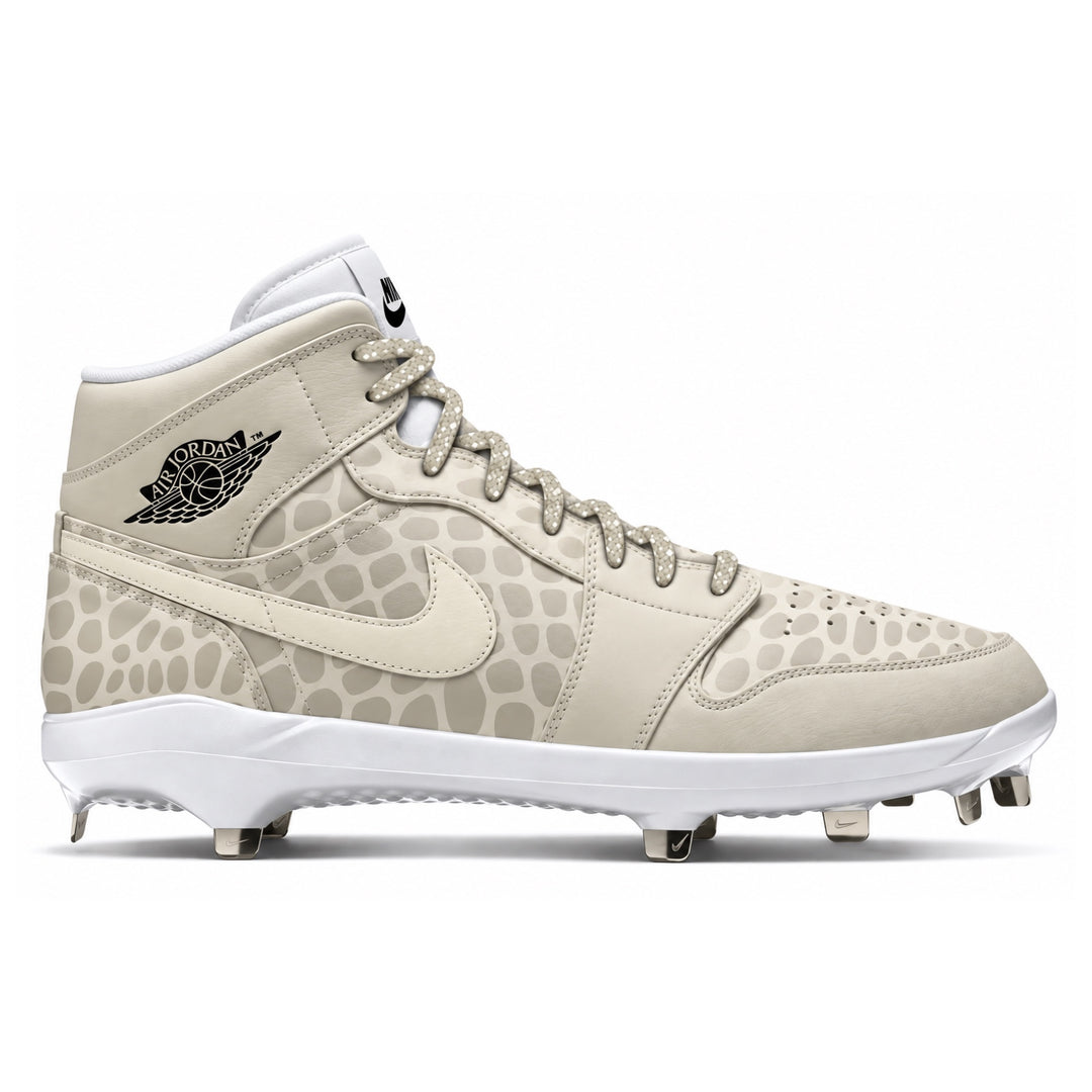 A Nike Air Jordan 1 high-top baseball cleat in a light beige and off-white snake skin colorway, featuring a subtle reptile-like pattern on the overlays and a black Jordan Wings logo on the heel.