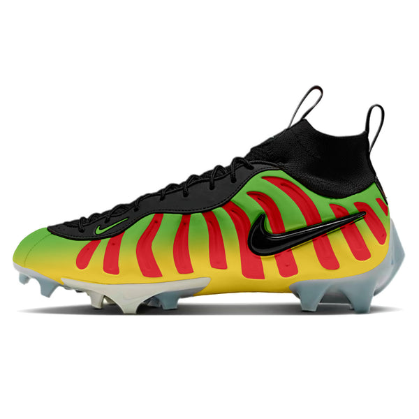 A pair of Nike Vaporposite Pro football cleats with a dinosaur theme, featuring green, yellow, and red colors and a textured, reminiscent of dinosaur skin.
