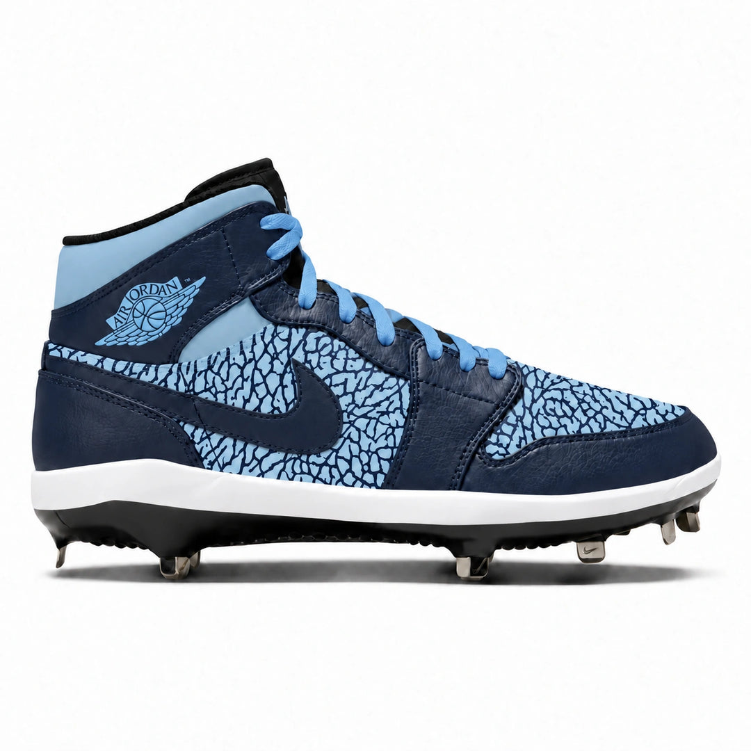A Nike high-top baseball cleat in navy blue and light blue, featuring a textured crackle pattern on the toe box and side, a black swoosh, and black cleats on a white midsole.