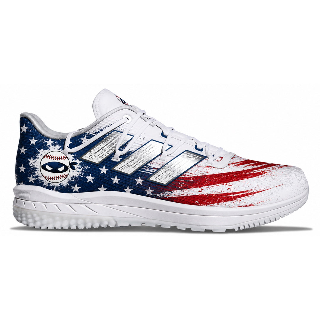 A white athletic cleat featuring a distressed American flag design with blue and red paint strokes and white stars, shown from the side on a white background.