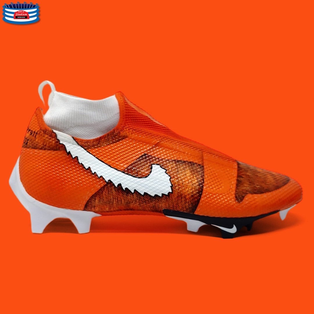Orange Nike soccer cleat from Full Custom collection displayed on a white background