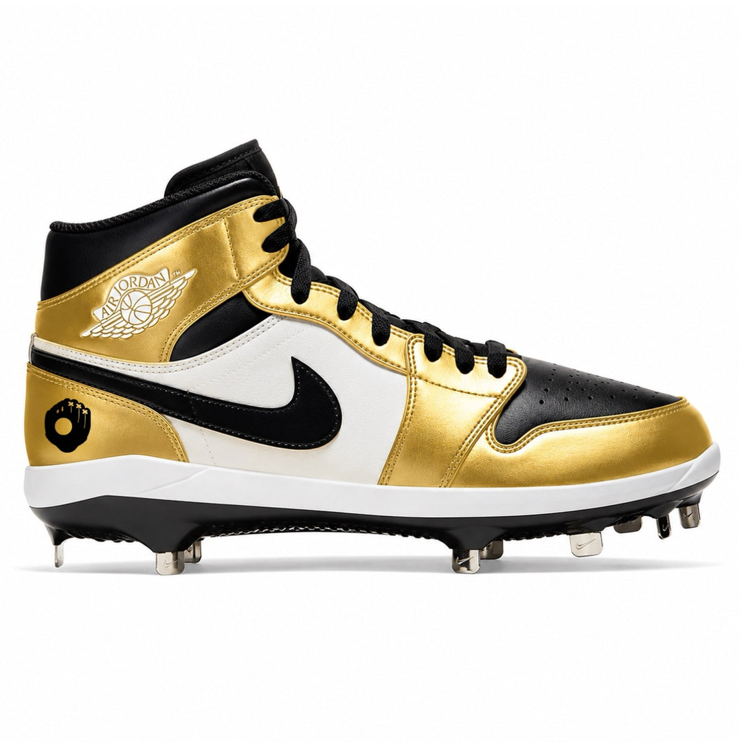 A high-top baseball cleat featuring metallic gold, black, and white panels, with a black Nike swoosh and a white Jordan Wings logo on the side.