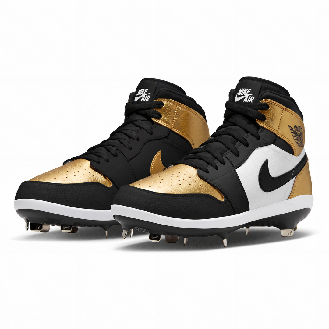 A pair of Nike Air mid-top baseball cleats in black, white, and metallic gold. The shoes feature a black leather base with metallic gold panels on the toe and ankle, a white side stripe with a black Nike swoosh, and gold and white Nike Air branding on the tongue and heel.