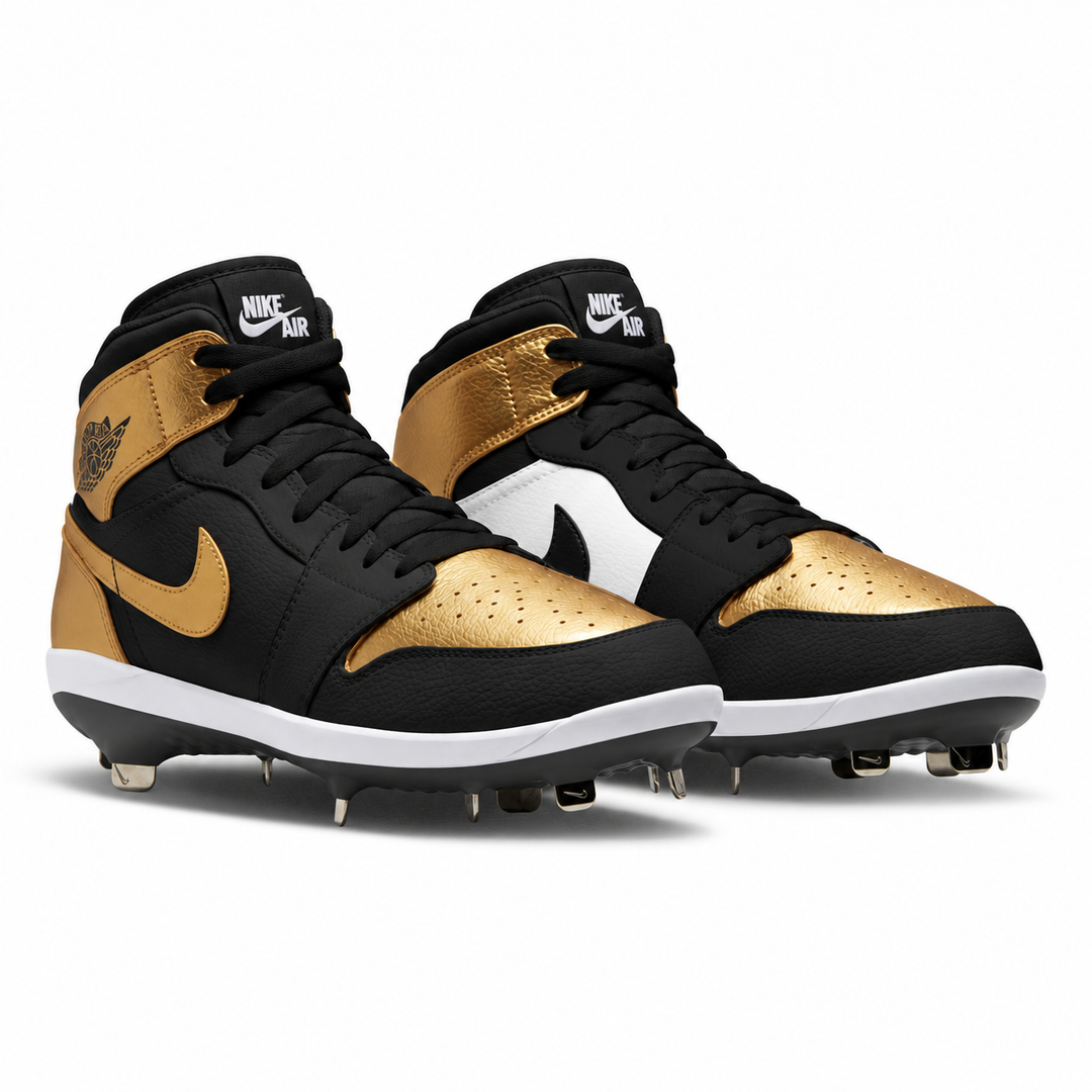 A pair of Nike Air mid-top baseball cleats in black, metallic gold, and white, shown from the side on a clean white background.