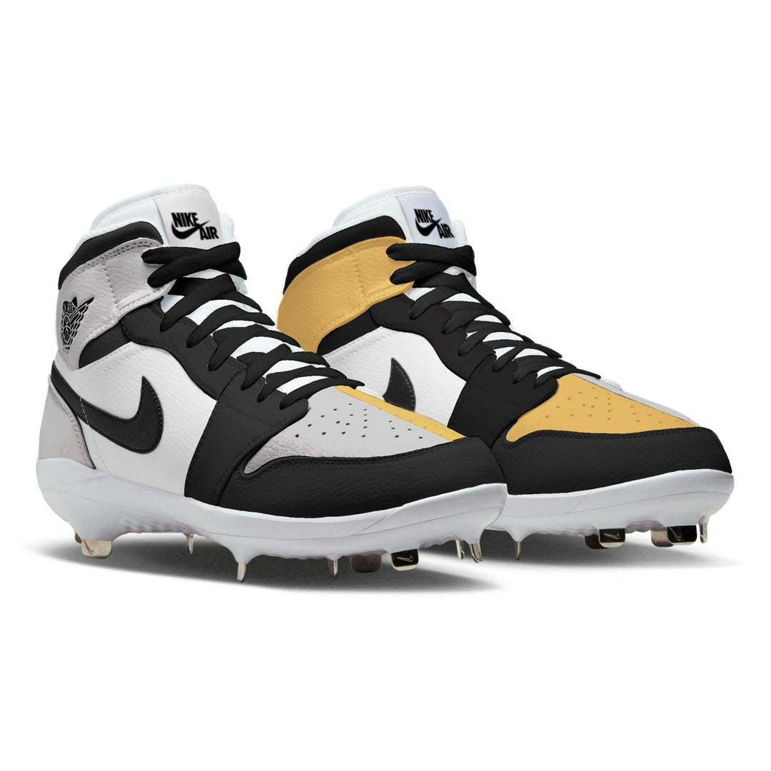 Pair of white, black, gold and silver baseball cleats on a white background