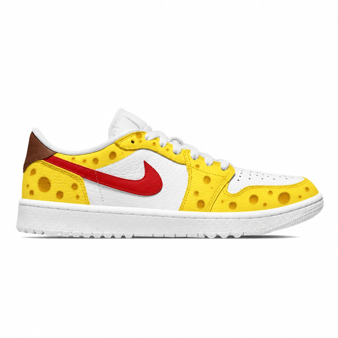 A Nike golf sneaker styled like a sponge, featuring a white leather base, bright yellow suede overlays with printed holes, a red Swoosh, a brown heel tab, and a white sole.
