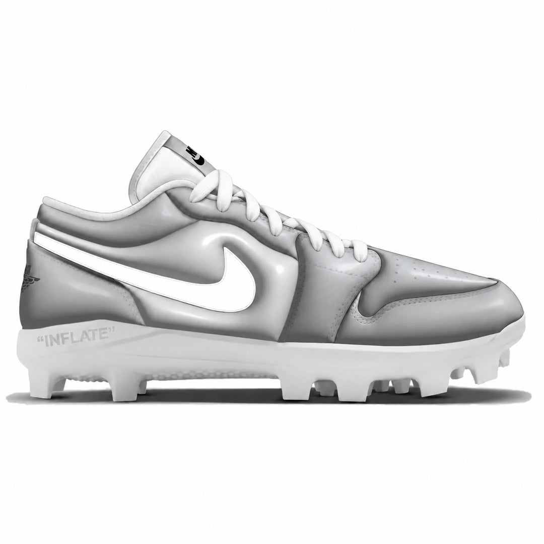 A Nike baseball cleats in gray and white, featuring a white Nike Swoosh on a gray side panel, white laces, and a white outsole with studs.