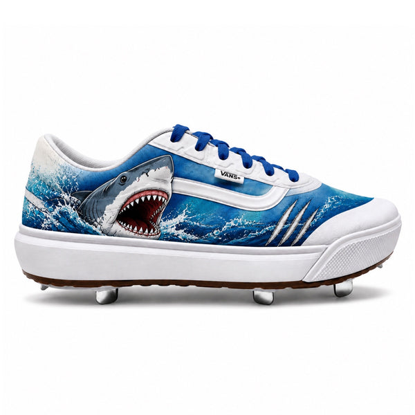 Great White Vans UltraRange 2.0 metal baseball cleats featuring a realistic great white shark bursting through crashing blue waves, white Vans sidewall stripe, royal blue laces, silver claw slash graphic, and a white cupsole with metal spike traction by Stadium Custom Kicks.