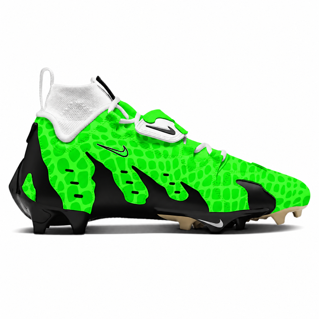 A Nike football cleat featuring a vibrant neon green crocodile-embossed pattern with black flame-like overlays, white laces and collar, and a white Nike swoosh on the side.
