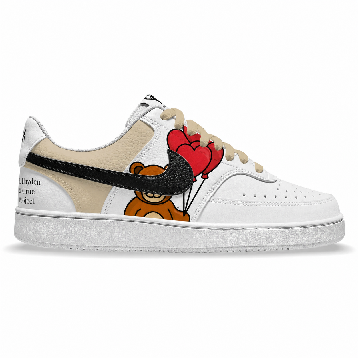 A white low-top sneaker featuring a beige leather heel panel with black text, a black swoosh overlay, a brown teddy bear graphic, and red heart-shaped balloons on the side, shown against a plain white background.