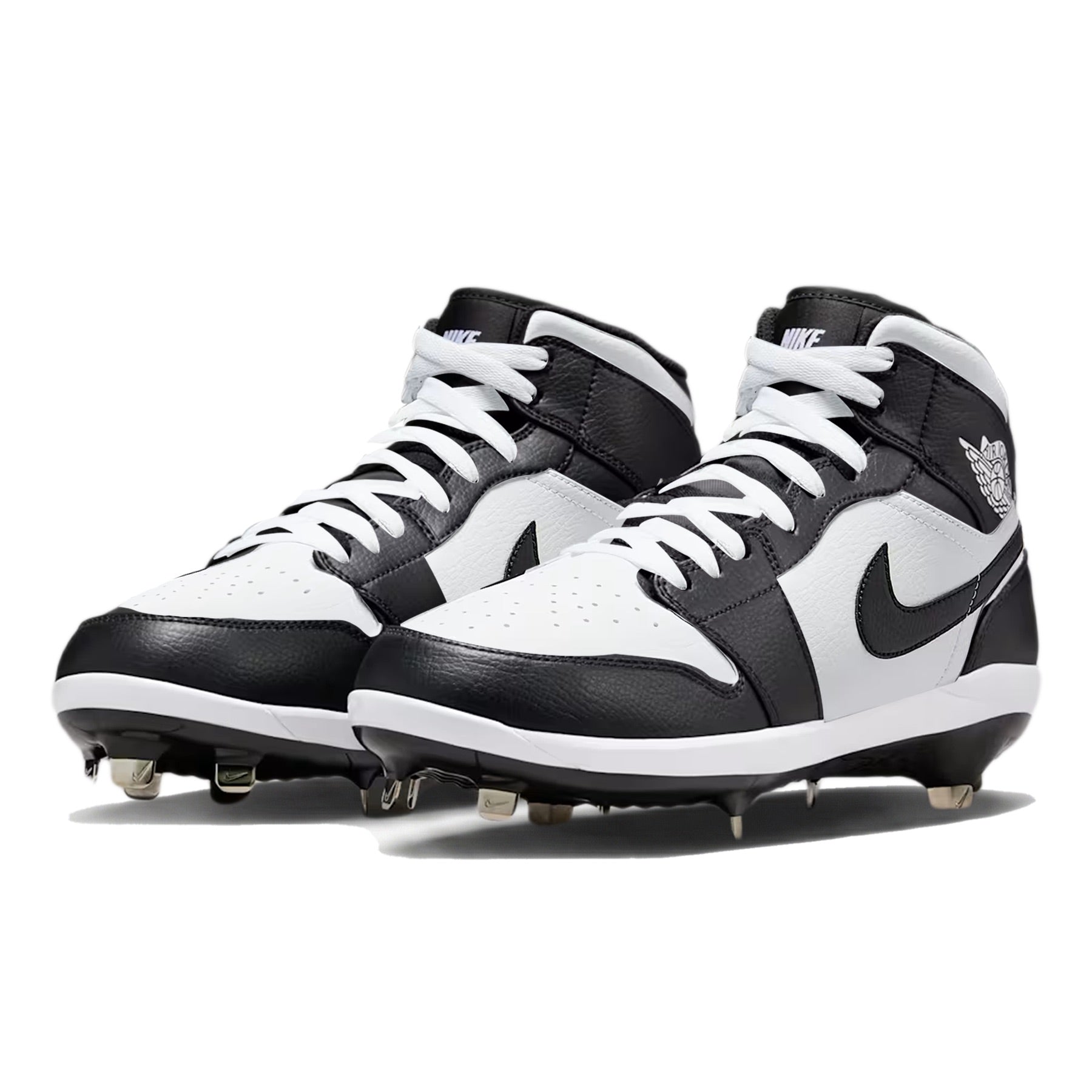 Angled view of custom Jordan 1 Retro Panda mid-top baseball cleats with metal spikes, hand-painted in black and white.