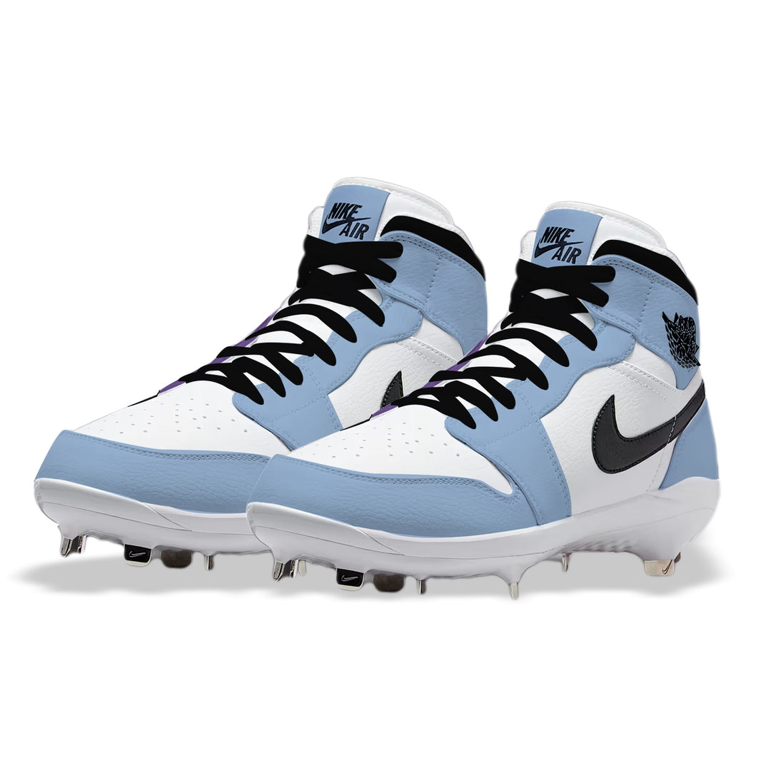 Angled view of custom Jordan 1 Retro University Blue mid-top baseball cleats with metal spikes, hand-painted in Carolina blue and white.