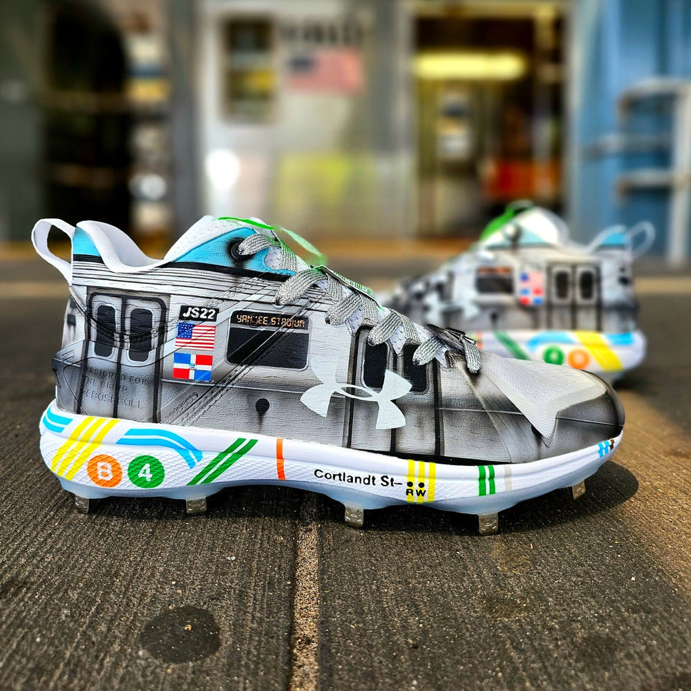 Baseball cleats with a train design on a platform
