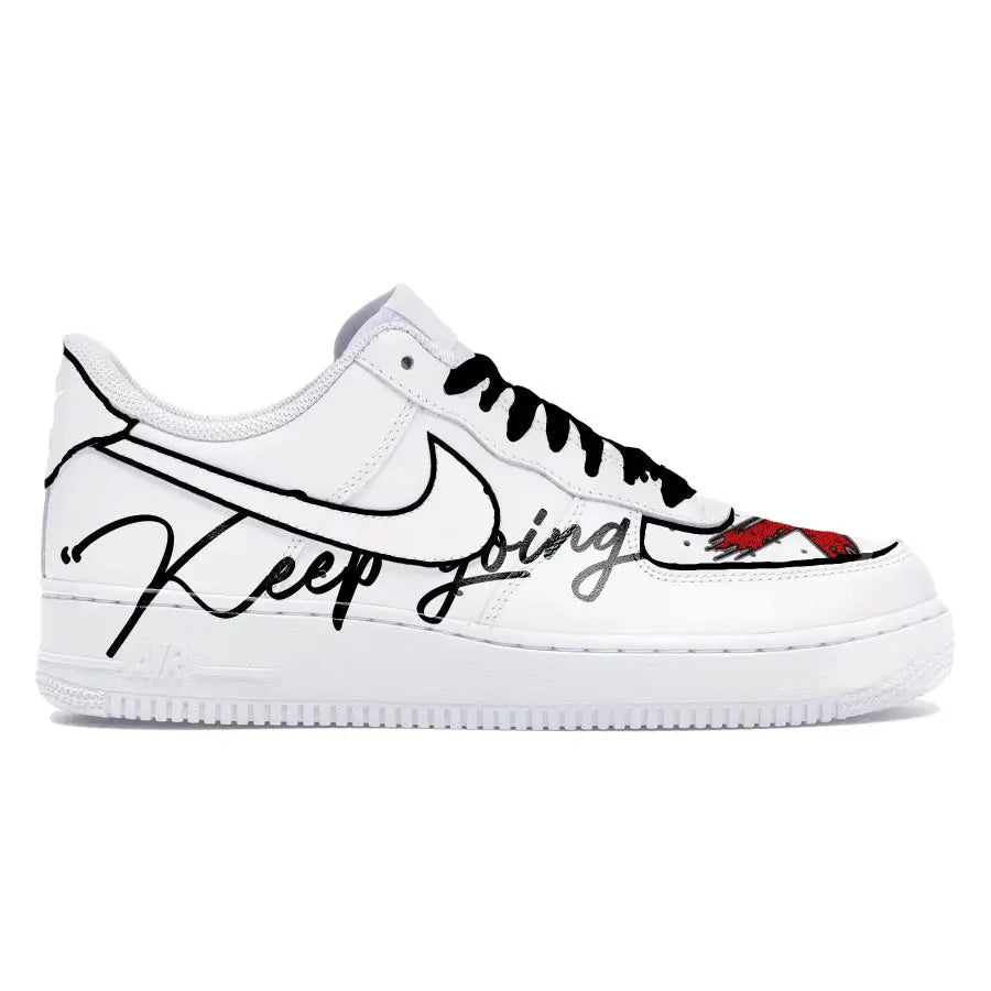 White sneaker with black and red text and graphics on a white background
