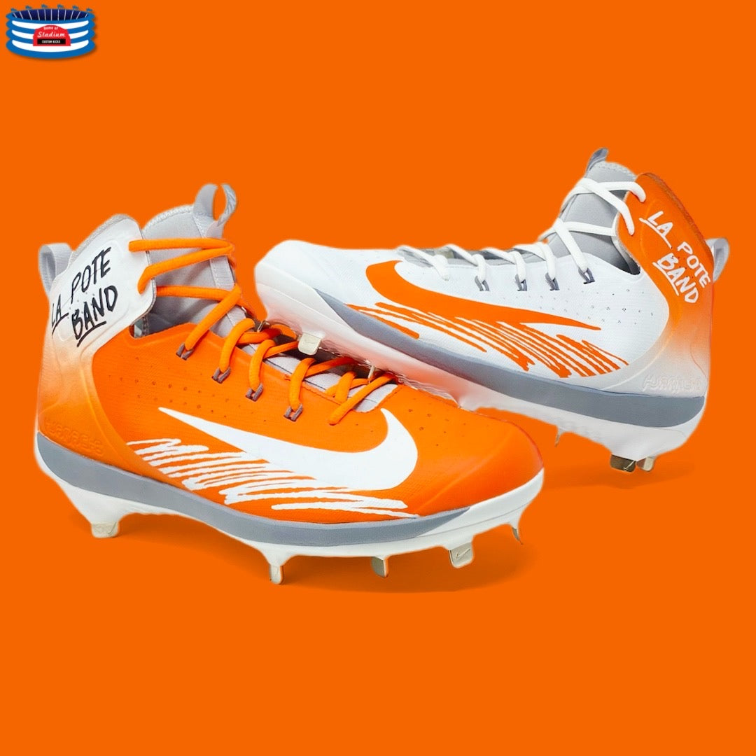 Orange and white baseball cleats with logo and simple design for optimal performance
