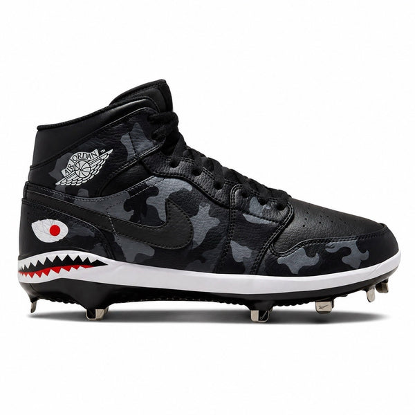 Nike Air Jordan 1 Retro Mid baseball cleat in black camo colorway, featuring a tonal charcoal camouflage leather upper, black Swoosh, shark-mouth graphic with red eye detail along the midsole, Air Jordan Wings logo on the collar, white midsole, and silver metal cleats by Stadium Custom Kicks