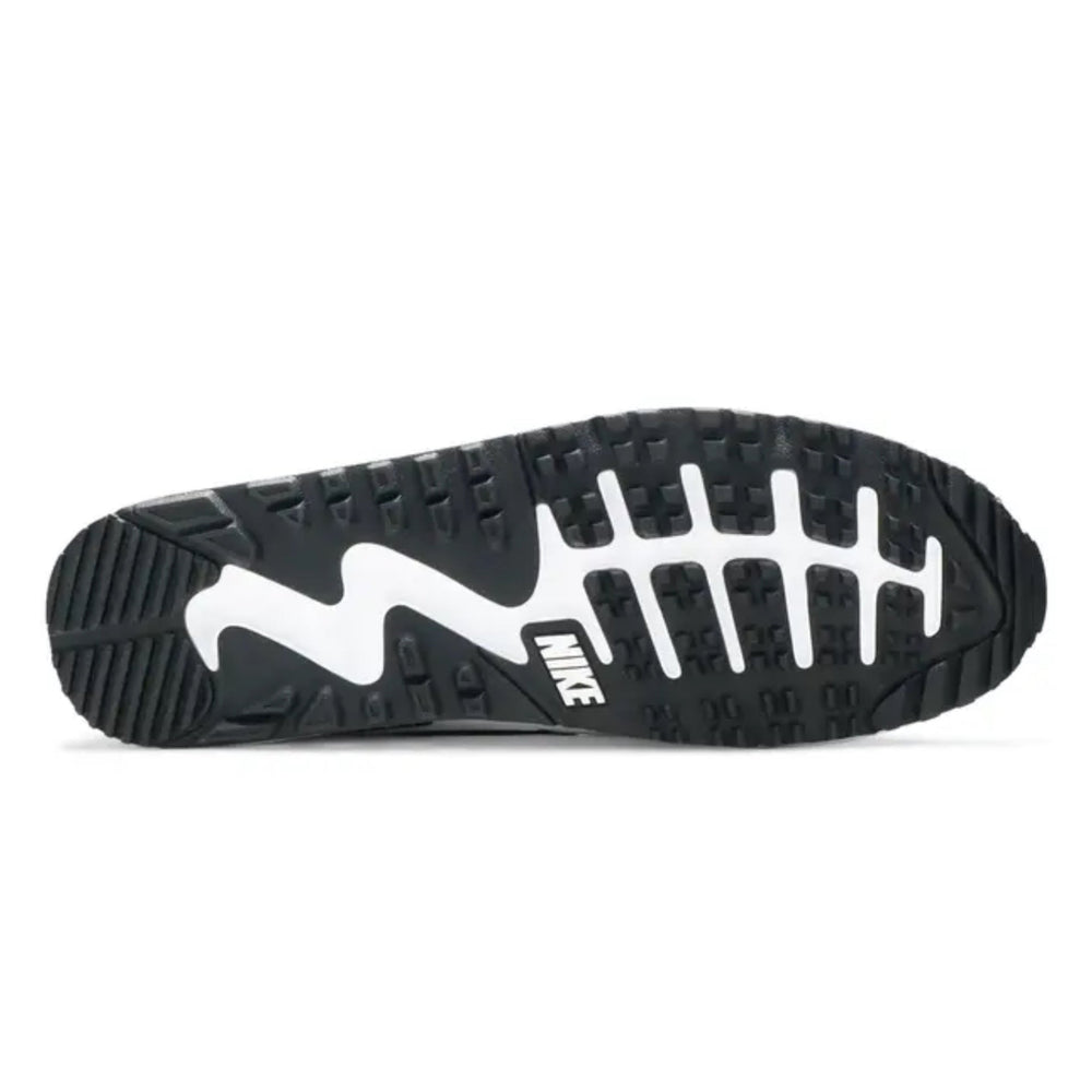 Black and white sole of a golf sneaker with Nike logo on a white background