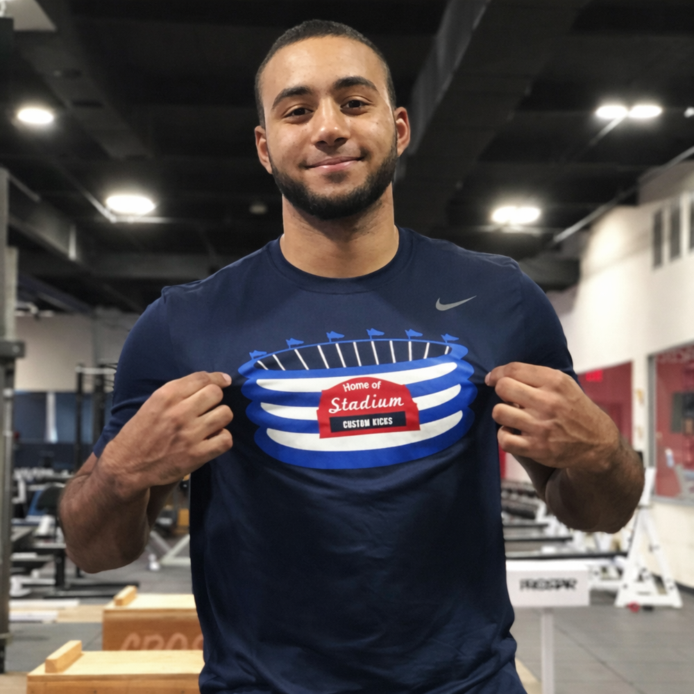 Man wearing a navy blue t-shirt with a graphic design in a gym setting