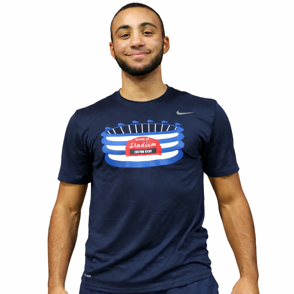 Man wearing a navy blue t-shirt with a stadium graphic on a white background